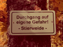 A German roadside sign reading: Durchgang auf eigene Gefahr! — Stierweide